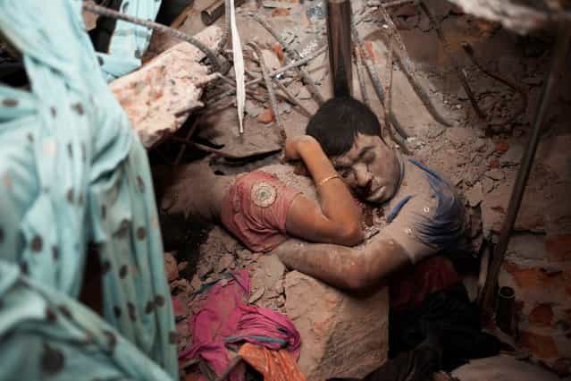 Two victims amid the rubble of a garment factory building collapse in Savar, near Dhaka, Bangladesh, April 25, 2013. (Photo by Taslima Akhter)