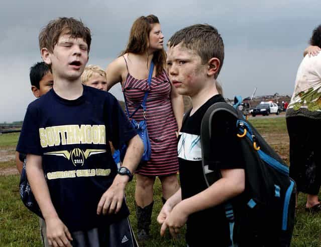 Children wait for their parents to arrive at Briarwood Elementary school after a tornado destroyed the school in south Oklahoma City. (Photo by Paul Hellstern/The Oklahoman)