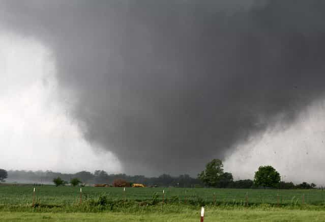 A monstrous, half-mile wide tornado with winds as high as 200 mph passes across south Oklahoma City on Monday. The tornado roared through the Oklahoma City suburbs, killing at least 51 people (including at least 20 children), flattening entire neighborhoods, setting buildings on fire and landing a direct blow on an elementary school. (Photo by Paul Hellstern/The Oklahoman)