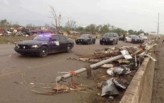 Law enforcement officials arrive on the scene after a huge tornado struck Moore, Oklahoma, near Oklahoma City, May 20, 2013. (Photo by Richard Rowe/Reuters)