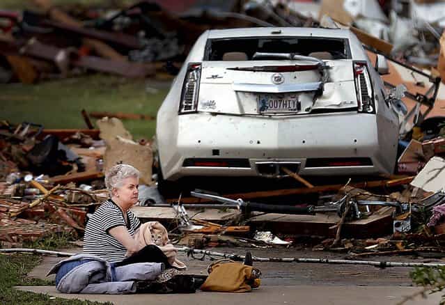 Kay James holds her cat as she sits in her driveway after her home in Oklahoma City was destroyed by the tornado. (Photo by Chris Landsberger/The Oklahoman)