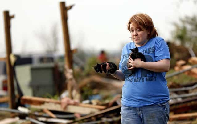 Rachel Hilton holds stray kittens she found in the debris of her parents' home at SW 149th and Stone Meadows Dr. after the tornado struck south Oklahoma City and Moore. (Photo by Nate Billings/The Oklahoman)