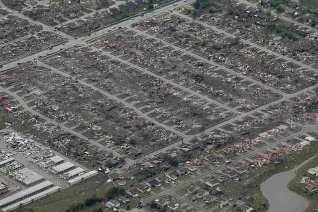 An aerial view of damage to neighborhoods in Moore, Oklahoma May 21, 2013, seen in the aftermath of a tornado which ravaged the suburb of Oklahoma City. Rescuers went building to building in search of victims and survivors picked through the rubble of their shattered homes on Tuesday, a day after a massive tornado tore through the Oklahoma City suburb of Moore, wiping out blocks of houses and killing at least 24 people. (Photo by Rick Wilking/Reuters)