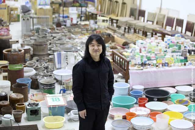 Chinese artist Song Dong stands in his installation entitled [Waste Not] in The Curve at the Barbican Art Gallery