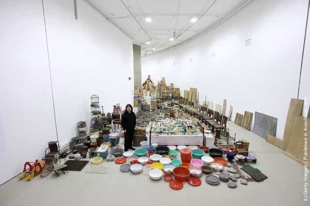 Chinese artist Song Dong stands in his installation entitled [Waste Not] in The Curve at the Barbican Art Gallery