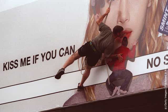 Royce Lemberg takes up the Smint challenge, kissing a billboard