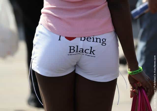 A woman wears shorts that read I love being Black