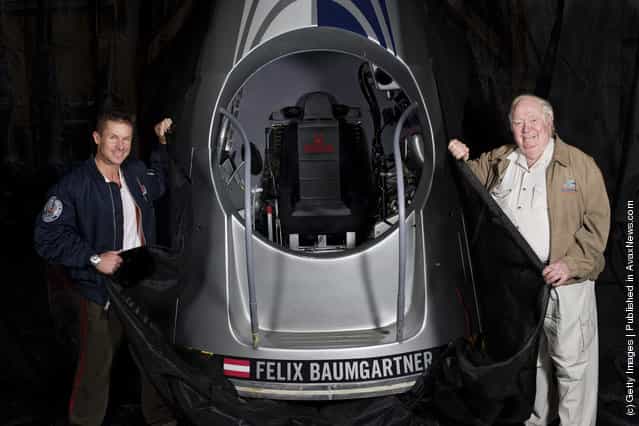 In this photo provided by Red Bull, Pilot Felix Baumgartner (L) of Austria and USAF colonel (ret.) Joe Kittinger of the United States pose with the capsule for Red Bull Stratos
