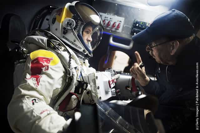 Pilot Felix Baumgartner (L) of Austria speaks with life support engineer Mike Todd of the United States during egress training in the capsule for Red Bull Stratos