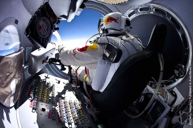 Pilot Felix Baumgartner of Austria prepares to exits the capsule before his jump during the first manned test flight for Red Bull Stratos