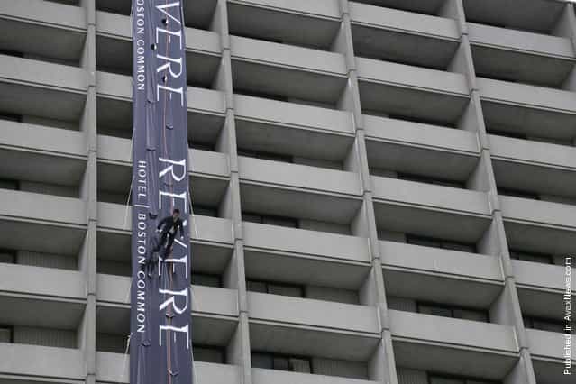 A model walks down the side of Revere Hotel in Boston during a vertical fashion show for the Massachusetts College of Art and Design