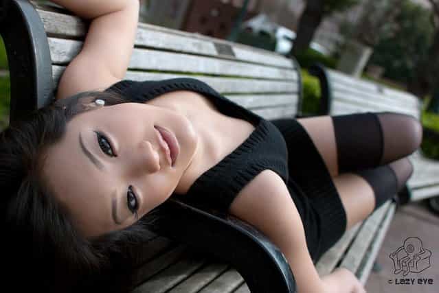 Sexy Asian Beauty. Mint reclines on the Bench
