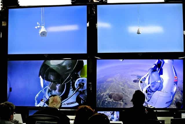 Baumgartner is seen on a screen at the project's mission control center as the balloon ascends. (Photo by Stefan Aufschnaiter/Red Bull)