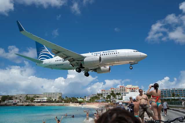 [Landing. In St Maarten, there is a named named Maho, directly across the street from Princess Juliana airport's landing strip. This gives adventurous beach-goers an unforgettable experience as planes come in. This particular plane is by no means the largest to land here]. (Photo by Paul Brousseau)