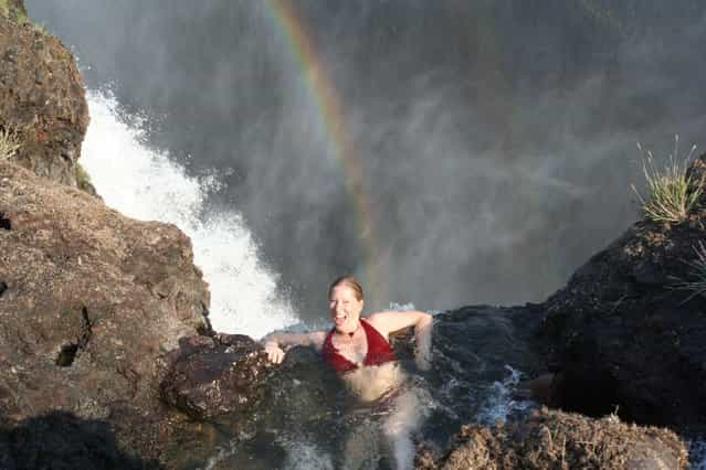 Angela with rainbow: Devil's Pool, Victoria Falls. (Photo by Fritz Stugren)