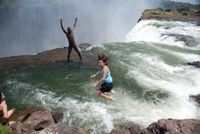 Michelle Jumping into Devil's Pool, Victoria Falls, Zambia. (Photo by Martin Callum)