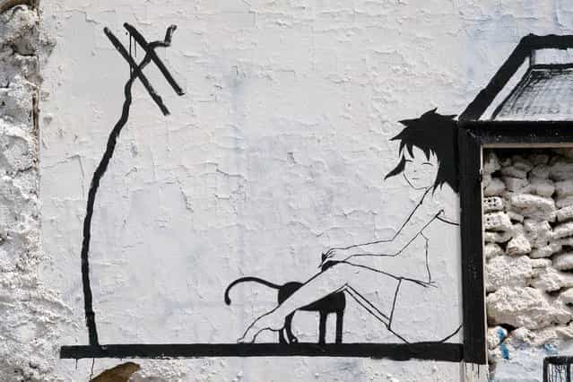 [A girl and her cat]. Athens street art, Greece. (Photo by Michel)
