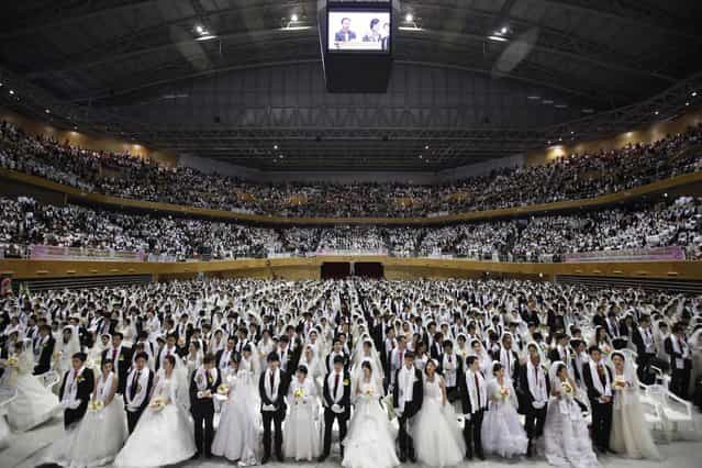 Thousands of newlyweds attend a mass wedding ceremony of the Unification Church at Cheongshim Peace World Centre in Gapyeong, about 60 km (37 miles) northeast of Seoul February 17, 2013. The Unification Church founded by evangelist reverend Moon Sun-myung in Seoul in 1954, performed its first mass wedding in 1961 with 33 couples. Approximately 3,500 couples attended the mass wedding on Sunday. (Photo by Kim Hong-Ji/Reuters)