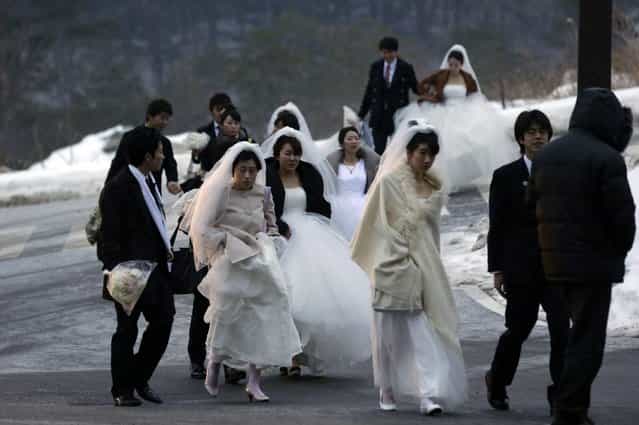 Couples arrive for their mass wedding ceremony at the CheongShim Peace World Center in Gapyeong, South Korea, Sunday, February 17, 2013. Some 3,500 South Korean and foreign couples exchanged or reaffirmed marriage vows in the Unification Church's mass wedding arranged by Hak Ja Han Moon, a wife of the late Rev. Sun Myung Moon, the controversial founder of the Unification Church. (Photo by Lee Jin-man/AP Photo)