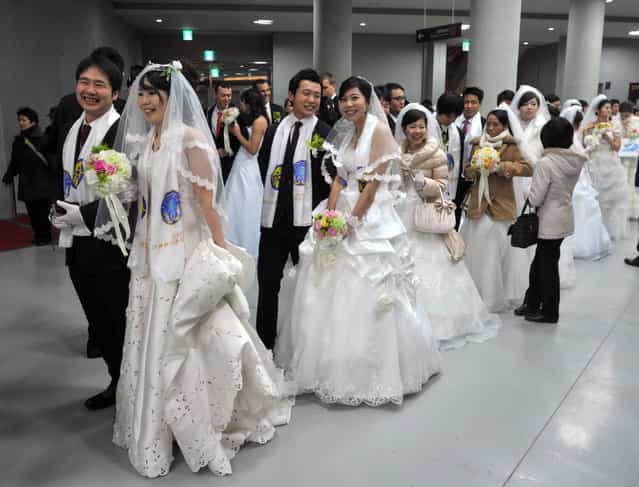 Couples attend a mass wedding organised by the Unification Church in Gapyeong on February 17, 2013. Some 3,500 couples married in a mass wedding organised by the Unification Church on February 17 – the first such event since the death of their "messiah" and controversial church founder Sun Myung Moon. (Photo by Kim Jae-Hwan/AFP Photo)