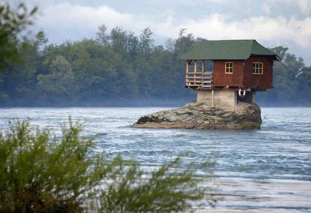 A house built on a rock on the river Drina is seen near the western Serbian town of Bajina Basta, about 160km (99 miles) from the capital Belgrade May 22, 2013. The house was built in 1968 by a group of young men who decided that the rock on the river was an ideal place for a tiny shelter, according to the house's co-owner, who was among those involved in its construction. (Photo by Marko Djurica/Reuters)