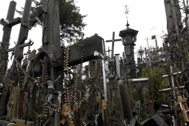 Rosary beads hang from a cross on Lithuania’s Hill of Crosses. (Photo by Richard Gardner/Rex USA)