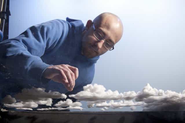 Matthew makes cotton clouds for his model, [Paradise]. (Photo by Matthew Albanese/Barcroft Media)