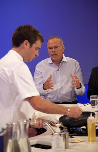 In this handout image provided by Ogilvy, Chef Richard McGeown (L) prepares a burger made from cultured beef, which has been developed by Professor Mark Post of Maastricht University in the Netherlands, (R) at the world's first public tasting of the product on August 5, 2013 in London, England. Cultured Beef could help solve the coming food crisis and combat climate change with commercial production of Cultured Beef beginning within ten to twenty years. (Photo by David Parry via Getty Images)