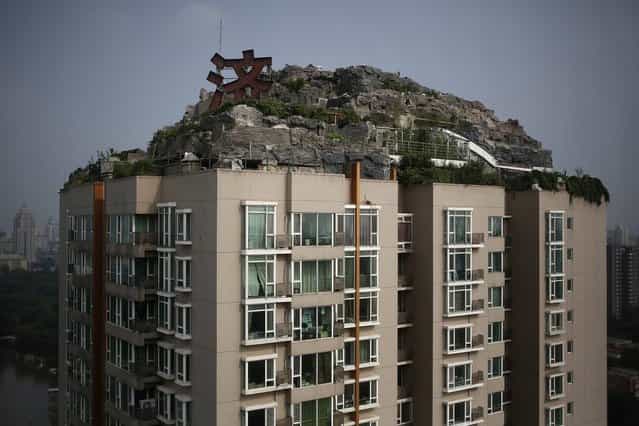 According to local media, the privately built villa seen here has been under construction on the rooftop of a residential building in downtown Beijing for the past six years. (Photo by How Hwee Young/European Pressphoto Agency)